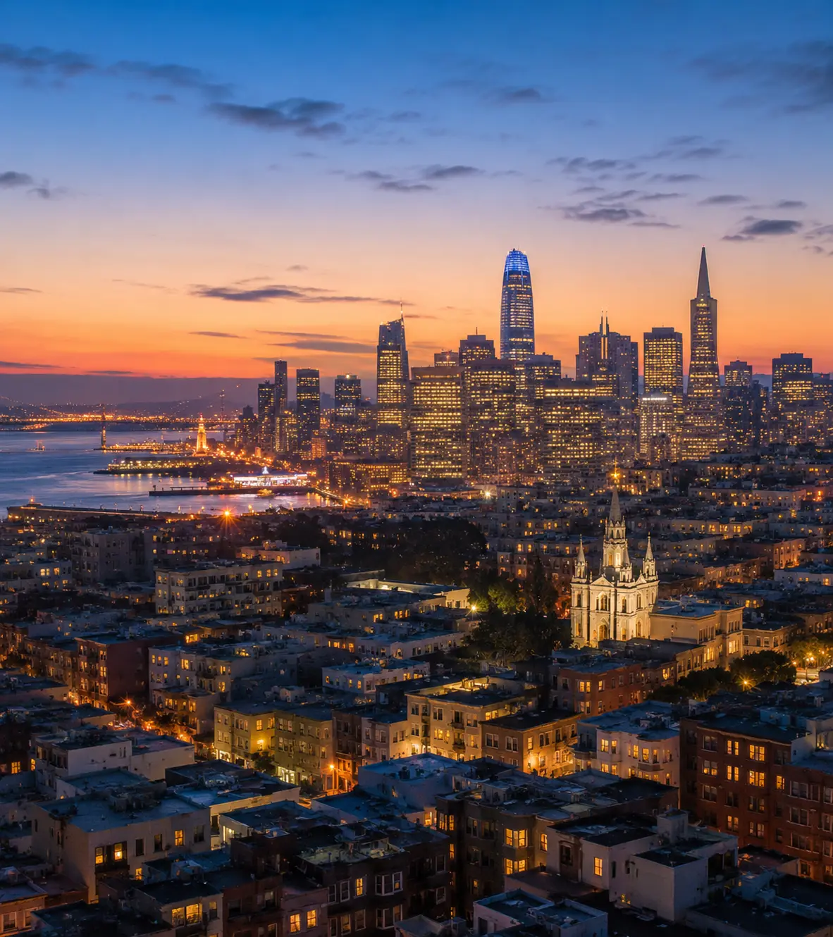 City skyline at dusk with lights just turning on